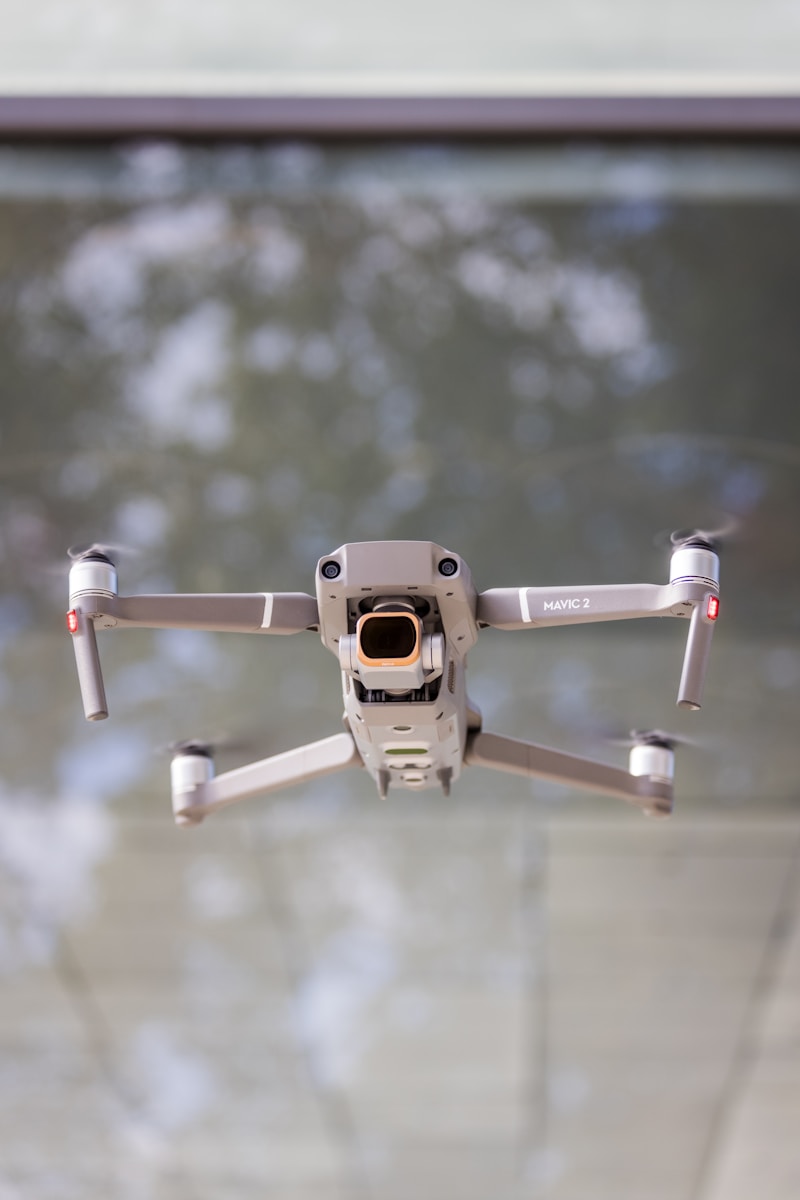 white and black drone in mid air